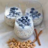 blueberry overnight oats in glasses with cashews