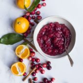 cranberry sauce in white bowl with clementines