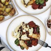 roasted cauliflower with saucy vegetables on white plate