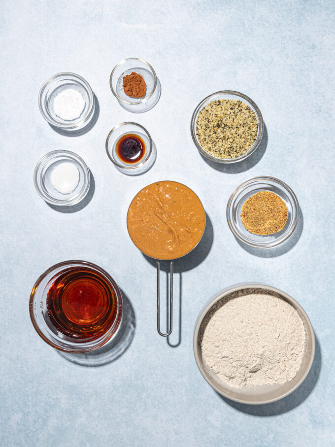 small bowls of hemp cookies ingredients: hemp hearts, peanut butter, rye flour, maple syrup