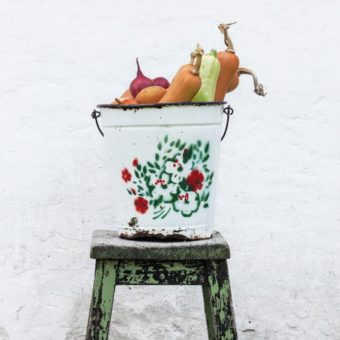 white bucket filled with vegetables on a table
