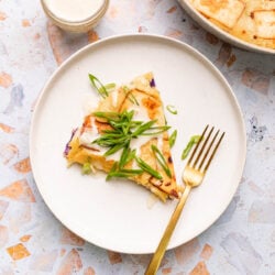 vegan okonomiyaki on a plate with fork and mayo