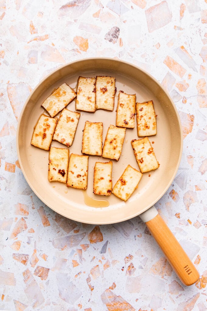 tofu slices in frying pan