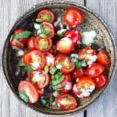Tomato Mint Salad with Creamy Dressing in Ceramic Bowl on Table