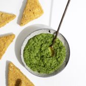 green sauce in bowl with spoon and tofu triangles