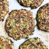 zucchini fritters on parchment paper