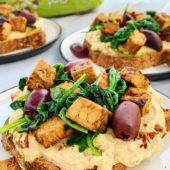 Hummus toast with tempeh, olives and spinach