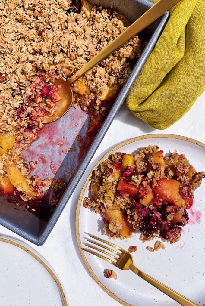 vegan peach blackberry crumble on white plate