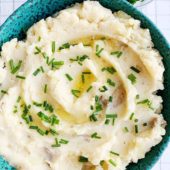 creamy vegan mashed potatoes in blue bowl with chives