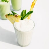 pina colada smoothie in glass with straw