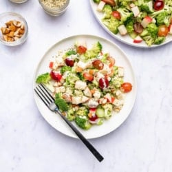 broccoli salad on white plate with almonds