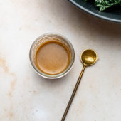 creamy balsamic salad dressing in a glass with spoon