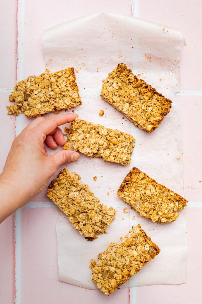 hand grabbing low fodmap granola bar on parchment