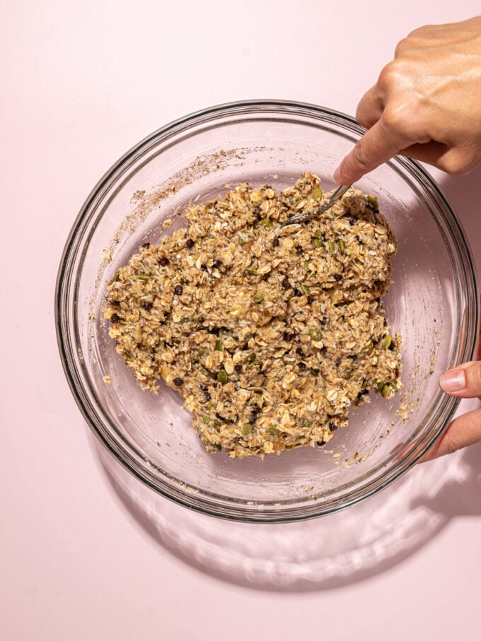 hand mixing bowl of oat cookie dough
