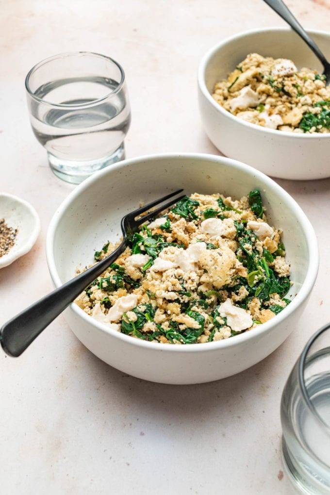 tofu scramble with spinach in white bowl