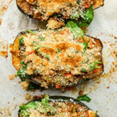 stuffed acorn squash on baking sheet