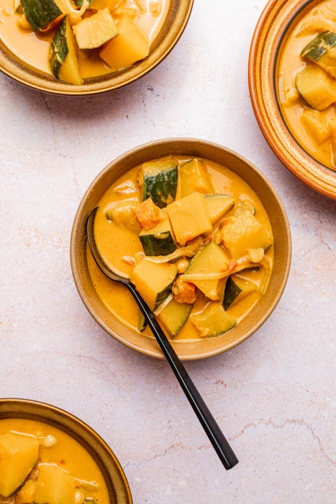 kabocha squash curry in bowls with spoon