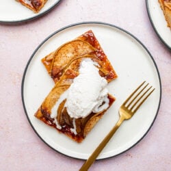 pear dessert tart with ice cream on a white plate with fork