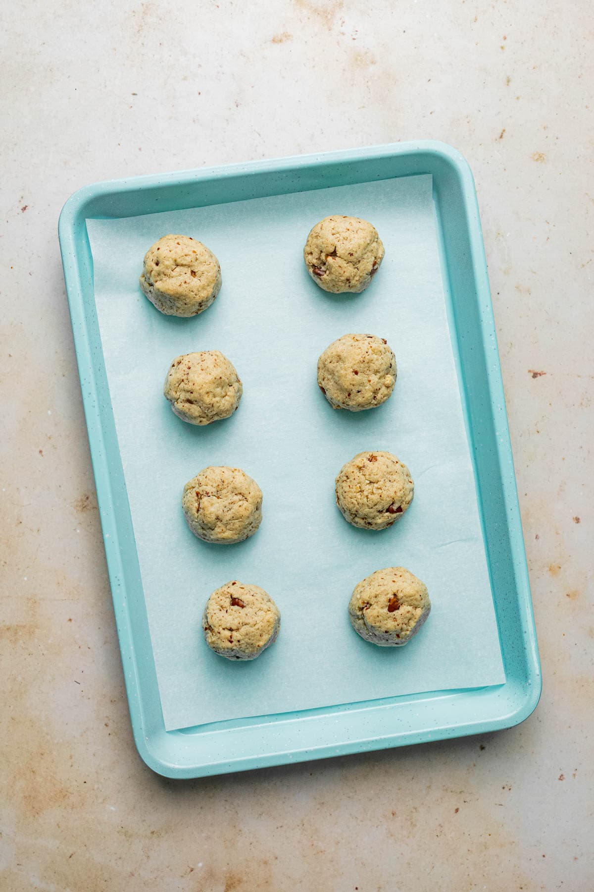 baked pecan snowball cookies on cookie sheet