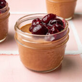 vegan chocolate mousse in glass jars with cherries