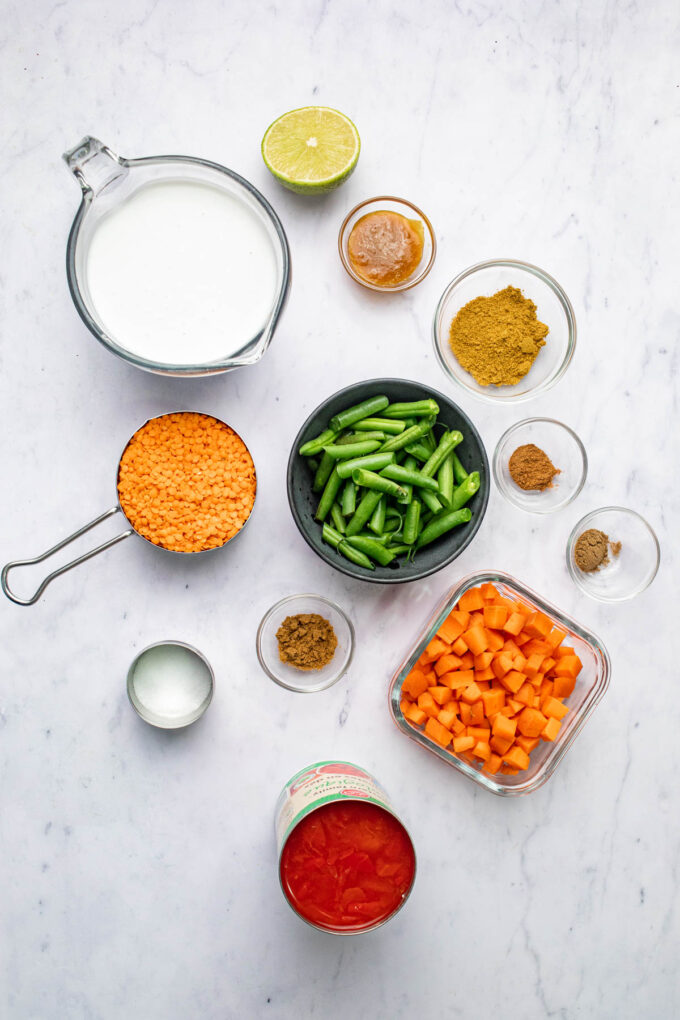 curried lentil tomato coconut soup ingredients in bowls