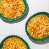 lemon chickpea orzo soup in blue bowls