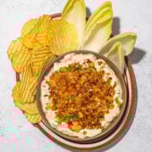tofu "fried pickle" dip with chips and endive on brown plate