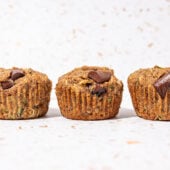 muffins with grated zucchini and chocolate chunks on terrazzo background