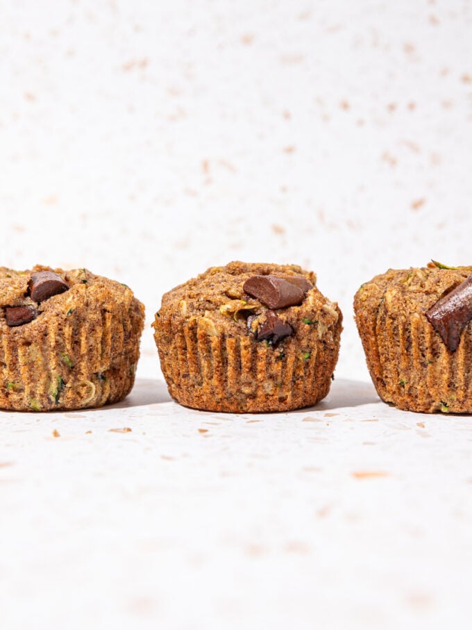 muffins with grated zucchini and chocolate chunks on terrazzo background