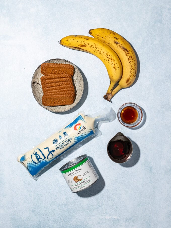bananas, biscoff cookies on plate, tube of silken tofu, coconut cream and spices