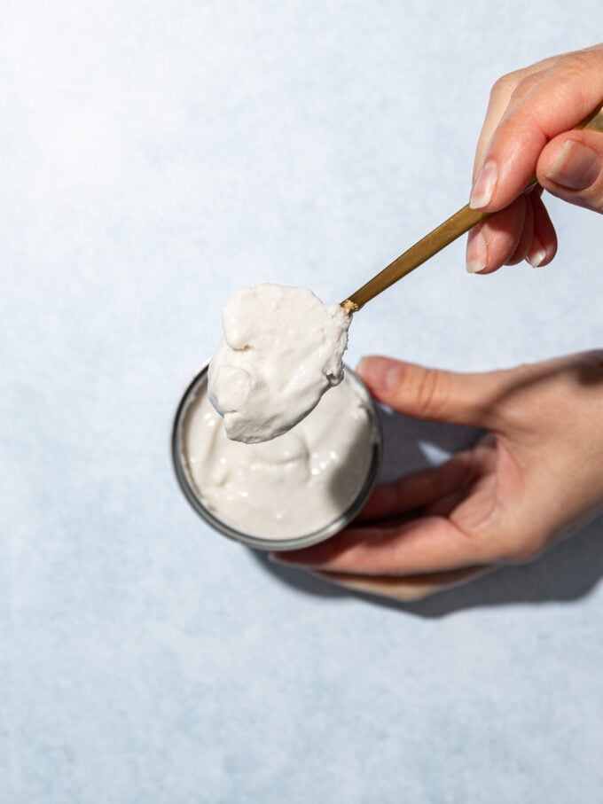 hand scooping coconut cream out of can