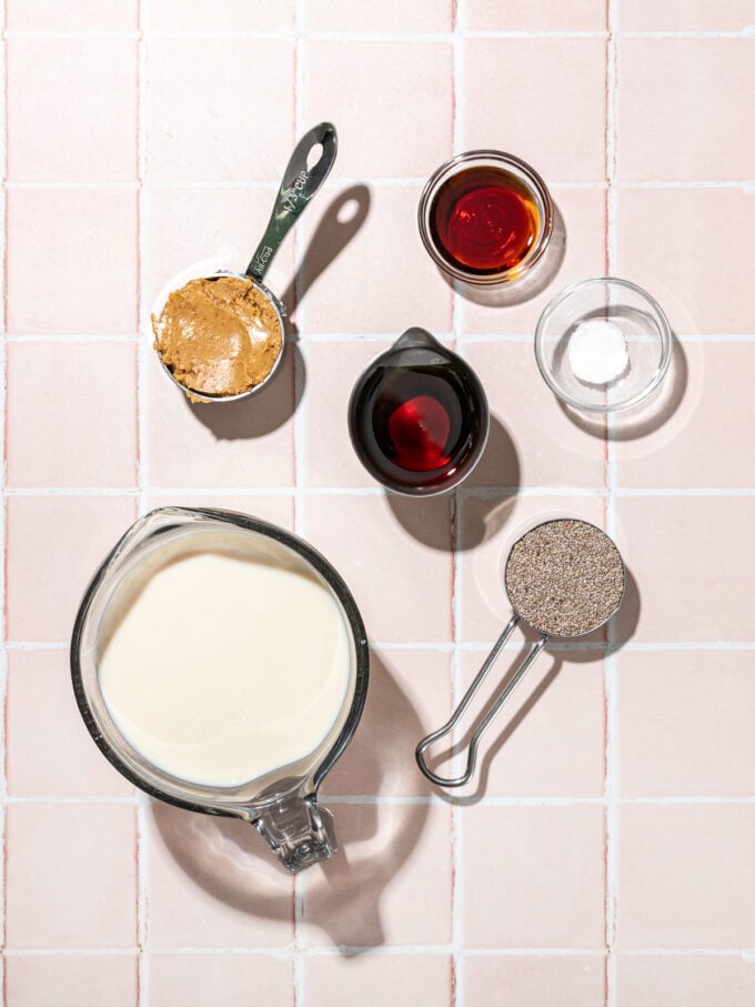 bowls of milk, maple syrup, chia seeds, peanut butter, vanilla, salt