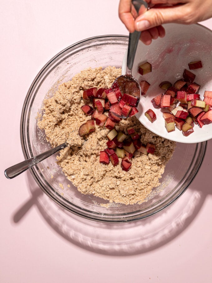 scooping rhubarb into dough with spoon
