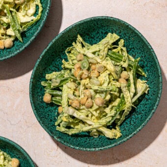 green goddess shredded cabbage and chickpea salad in 3 blue bowls