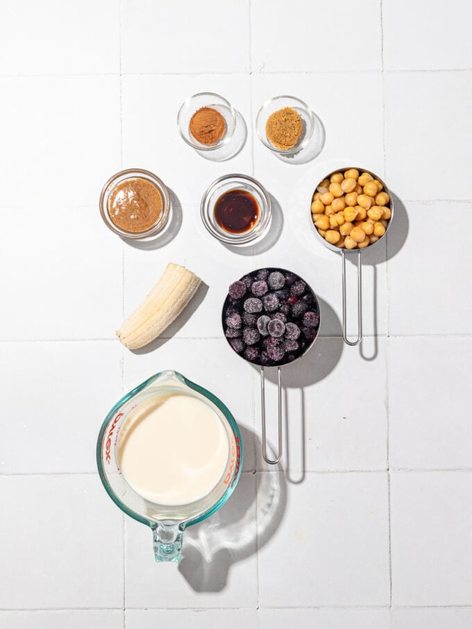 bowls filled with chickpeas, blueberries, soy milk, vanilla and almond butter