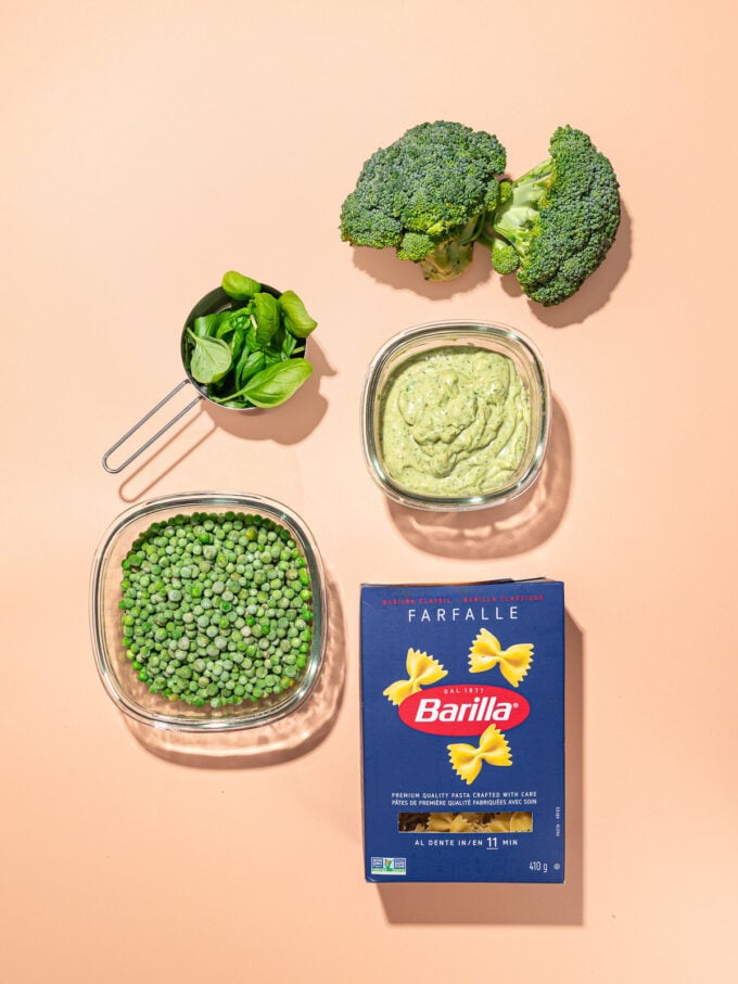 box of pasta, bowls of peas, green goddess dressing, basil and broccoli