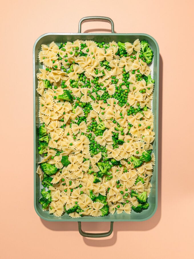 baking tray with cooked pasta and broccoli