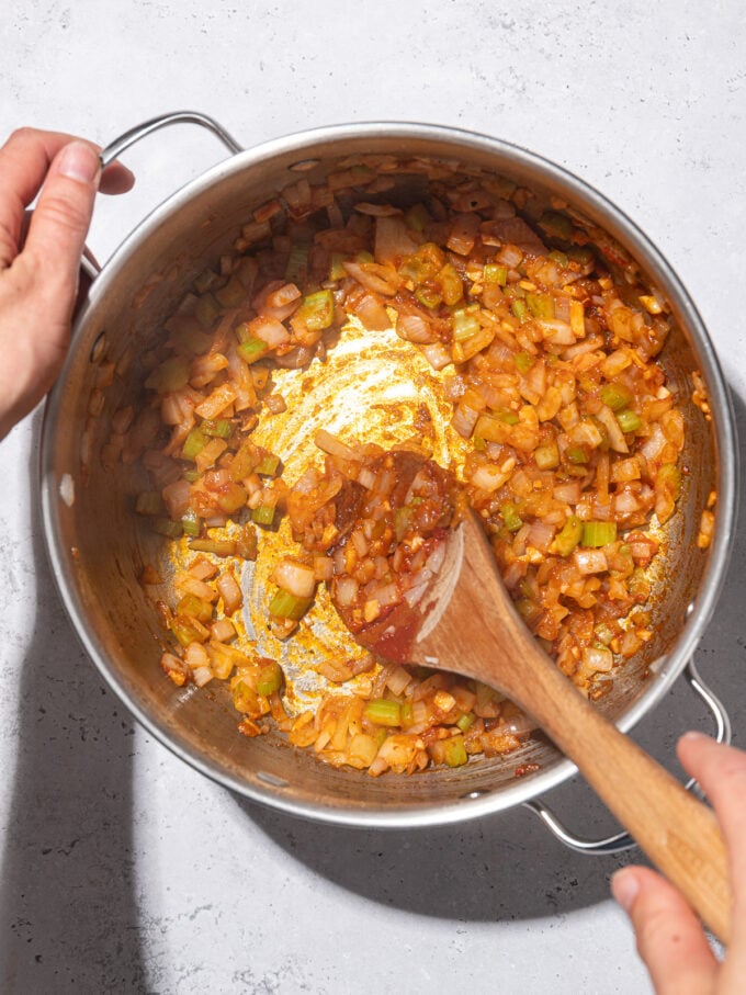 mixing better than bouillon into diced veggies in soup pot with wooden spoon