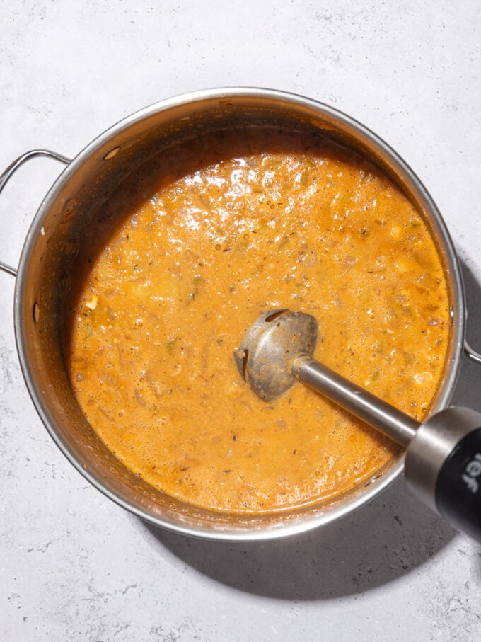 immersion blender in pot of white bean stew