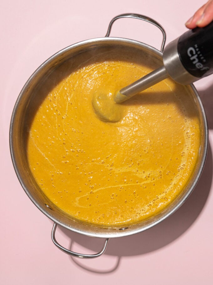blending butternut squash soup with immersion blender in soup pot