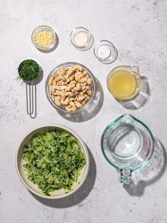 bowls of cashews, grated cucumber, lemon juice, garlic, fresh dill and water