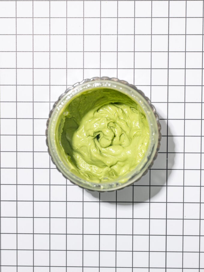 blender jar of creamy avocado dressing seen from overhead