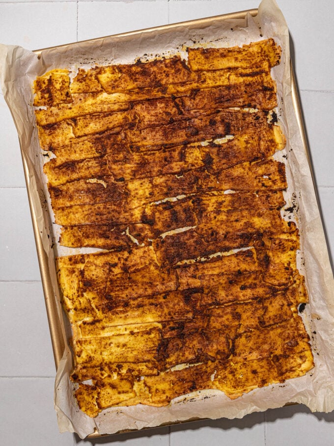 baked tofu shawarma on parchment lined baking sheet